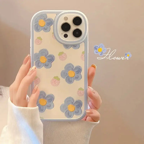 A woman holding a phone case with flowers on it