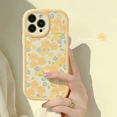 A woman holding a phone case with flowers on it