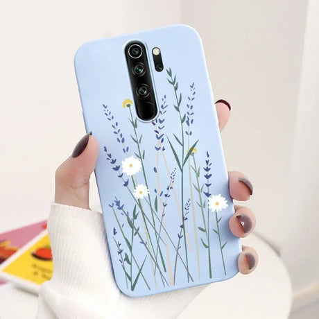 A woman holding a phone case with flowers on it