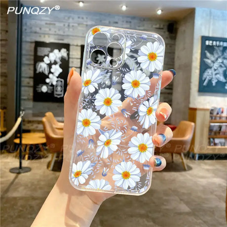 A woman holding a phone case with flowers on it