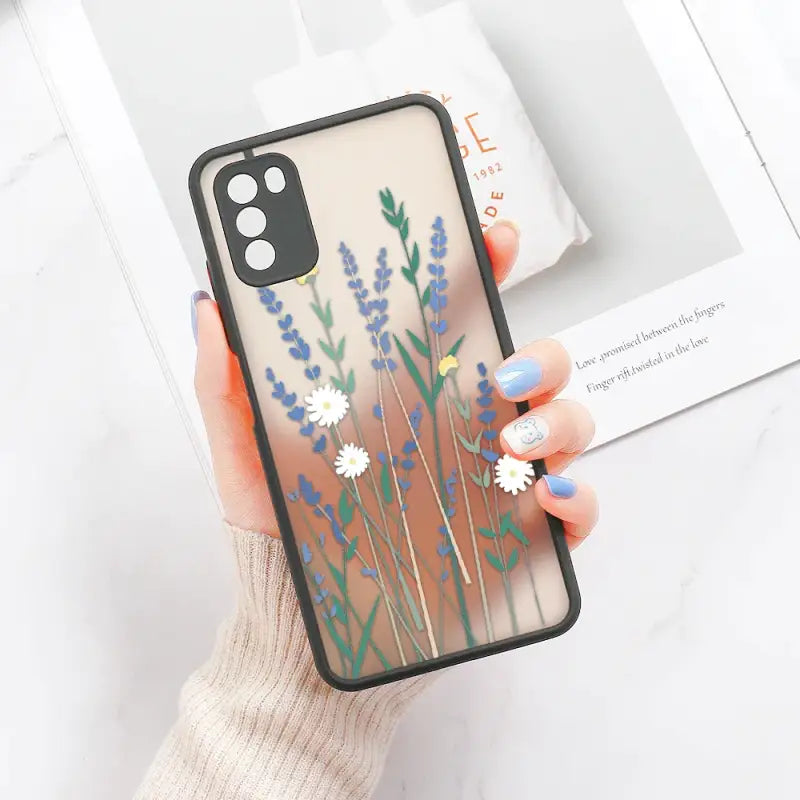 a woman holding a phone case with flowers on it