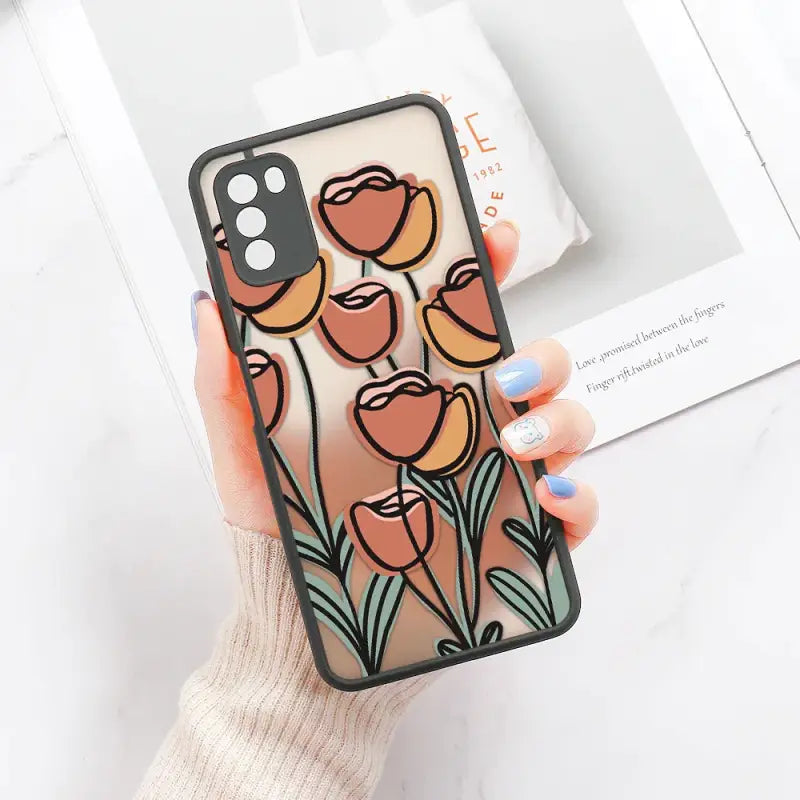 A woman holding a phone case with flowers on it