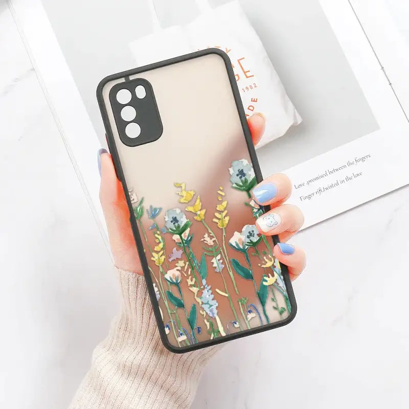 a woman holding a phone case with flowers on it