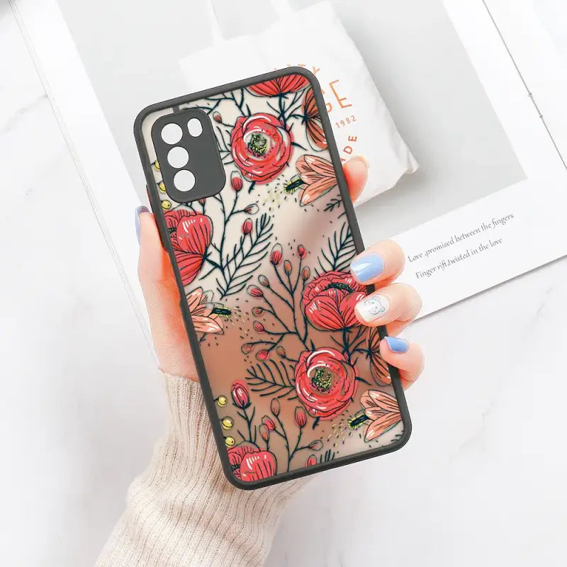 a woman holding a phone case with flowers on it