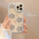 A woman holding a phone case with flowers on it