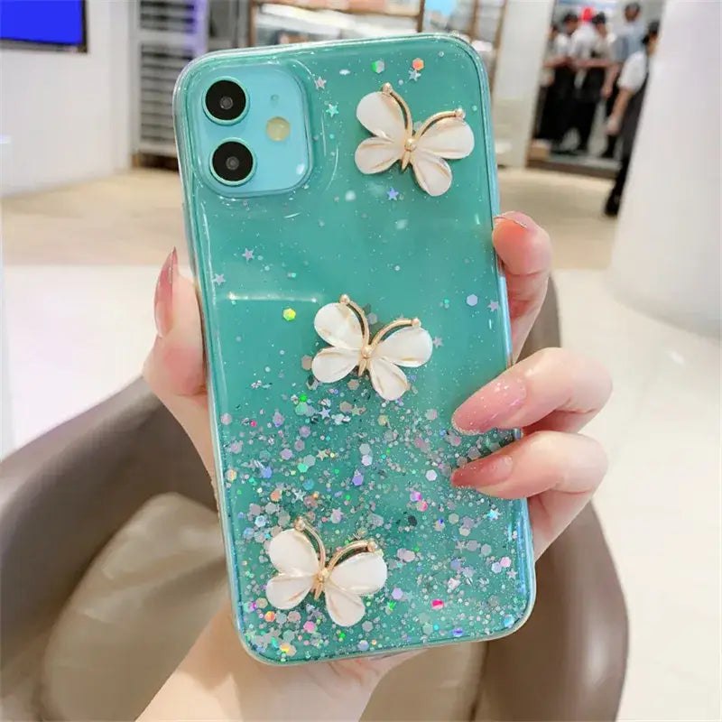 a woman holding a phone case with flowers on it