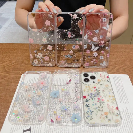 A woman holding a phone case with flowers on it