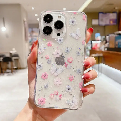 A woman holding a phone case with flowers on it