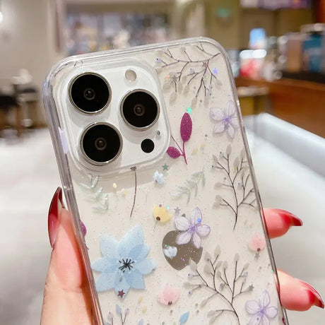 A woman holding a phone case with flowers on it