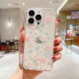 A woman holding a phone case with flowers on it