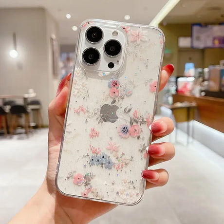 A woman holding a phone case with flowers on it