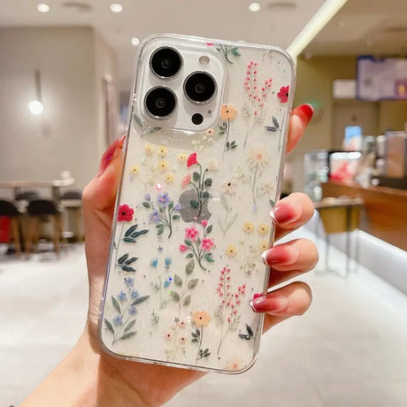 A woman holding a phone case with flowers on it