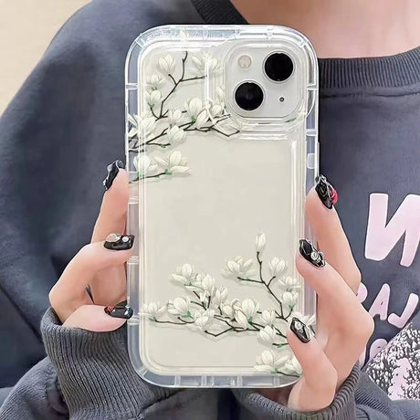 a woman holding a phone case with flowers on it