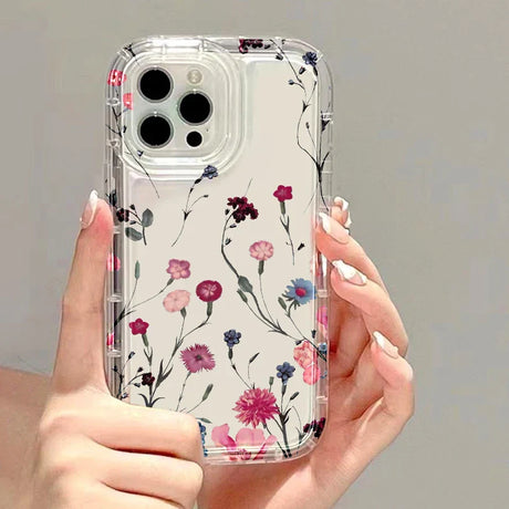 a woman holding a phone case with flowers on it