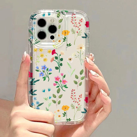 a woman holding a phone case with flowers on it