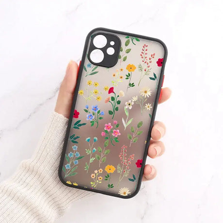 A woman holding a phone case with flowers on it