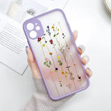 A woman holding a phone case with flowers on it