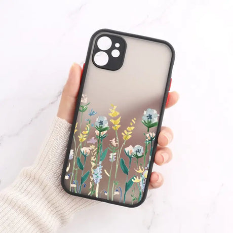 A woman holding a phone case with flowers on it