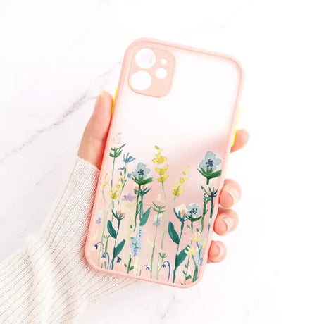 A woman holding a phone case with flowers on it