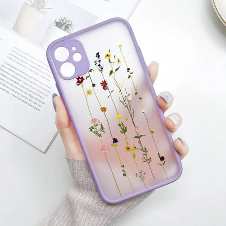 A woman holding a phone case with flowers on it