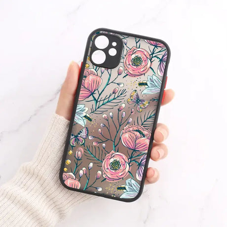 A woman holding a phone case with flowers on it