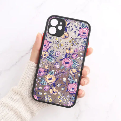 A woman holding a phone case with flowers on it