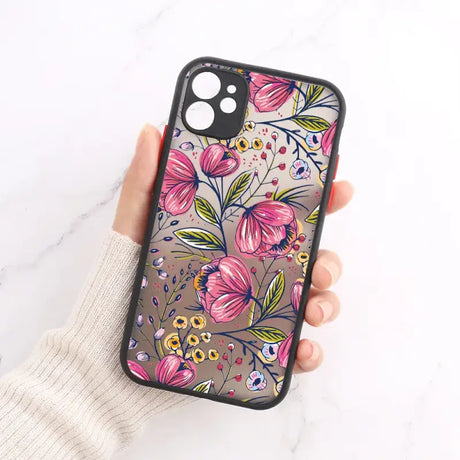 A woman holding a phone case with flowers on it