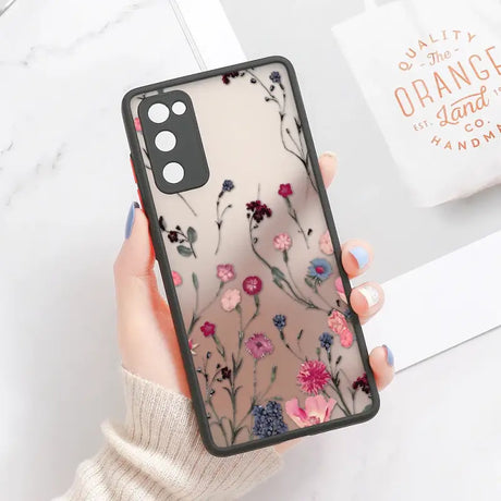 A woman holding a phone case with flowers on it