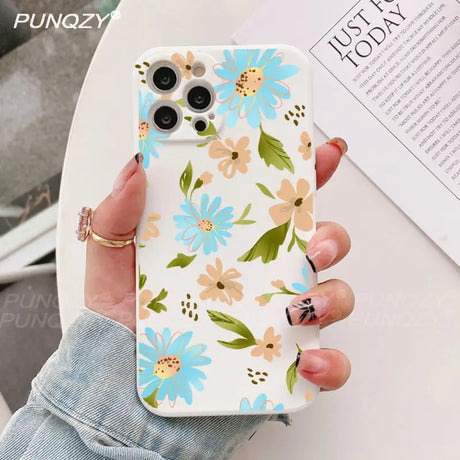 A woman holding a phone case with flowers on it