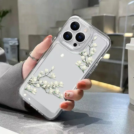 A woman holding a phone case with flowers on it