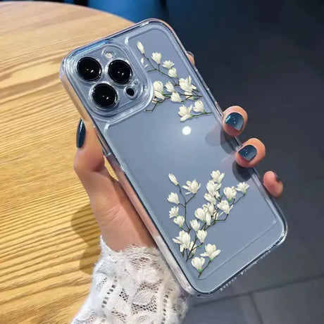 A woman holding a phone case with flowers on it