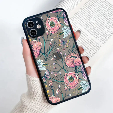 A woman holding a phone case with flowers on it