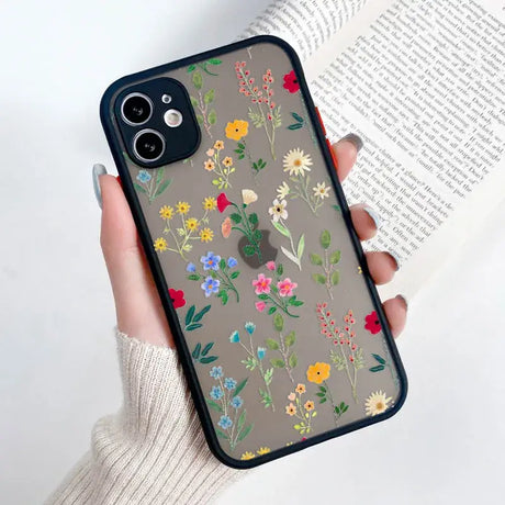 A woman holding a phone case with flowers on it