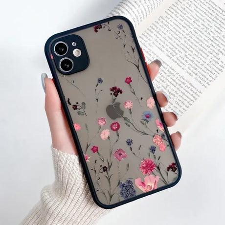 A woman holding a phone case with flowers on it