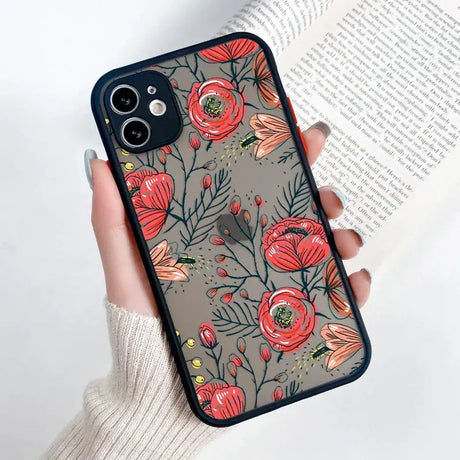 A woman holding a phone case with flowers on it