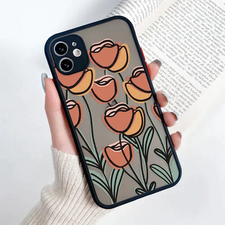 A woman holding a phone case with flowers on it