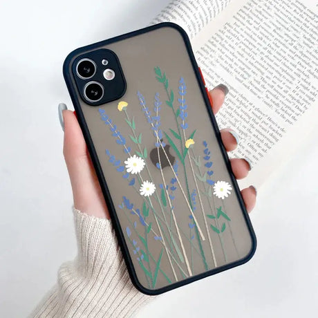 A woman holding a phone case with flowers on it