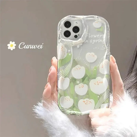 A woman holding a phone case with flowers on it