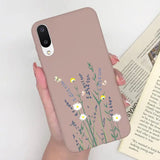 a woman holding a phone case with flowers on it