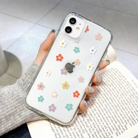 A woman holding a phone case with flowers on it