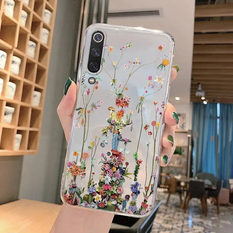 A woman holding a phone case with flowers on it