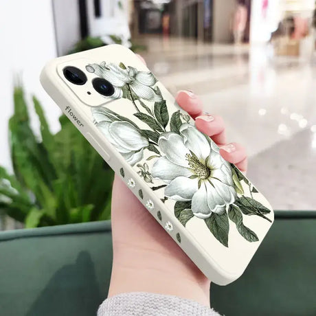 A woman holding a phone case with flowers on it