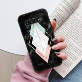 a woman holding a phone case with a geometric design