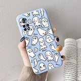 A woman holding a phone case with ghost pattern