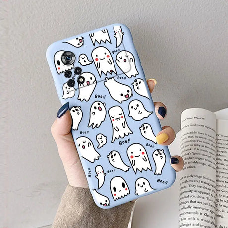 A woman holding a phone case with ghost pattern