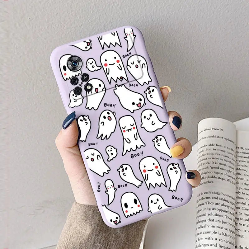 a woman holding a phone case with ghost pattern