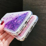 a woman holding a phone case with glitter on it