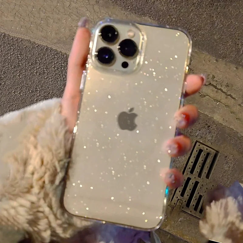 a woman holding a phone case with glitter on it