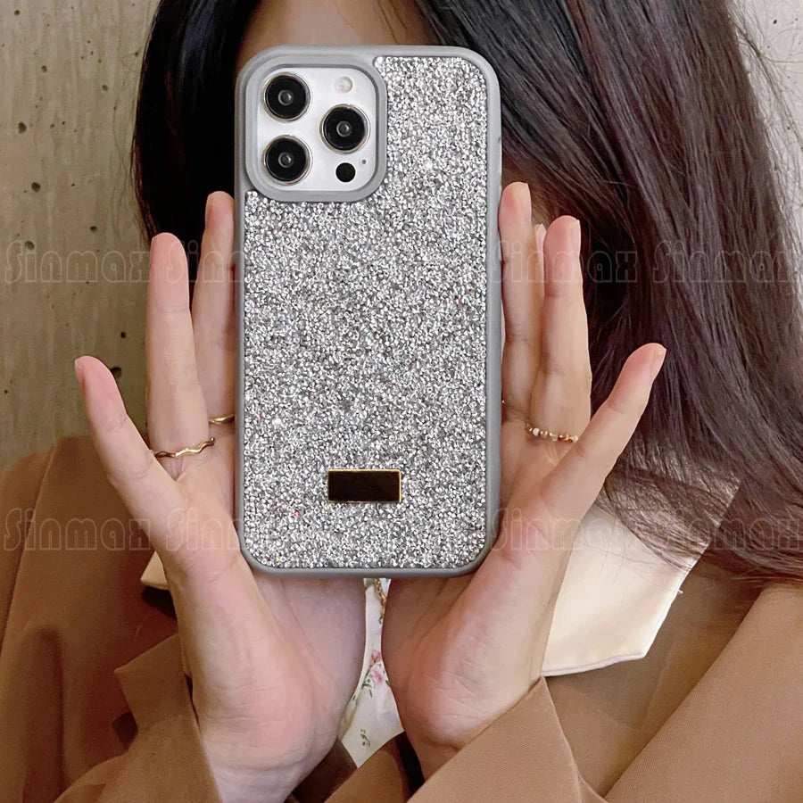 a woman holding a phone case with glitter