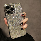 a woman holding a phone case with a glitter design